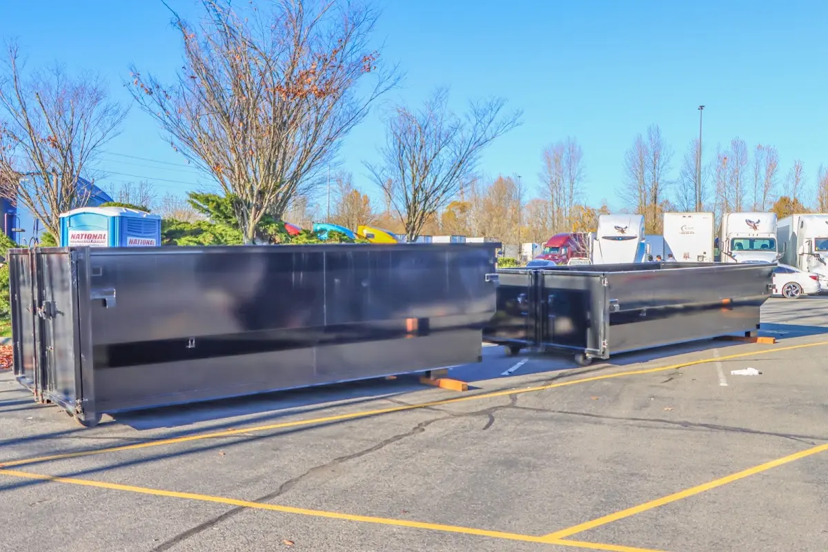 Professional dumpster rental service with roll-off container on residential driveway in Lindale